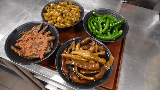 Various chili side dishes on tray