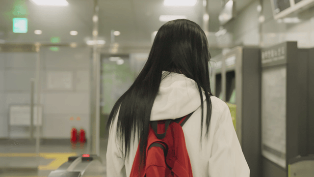 Young woman exiting subway gate