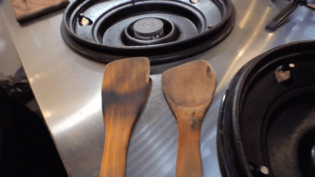 Old wooden spatulas on kitchen stove