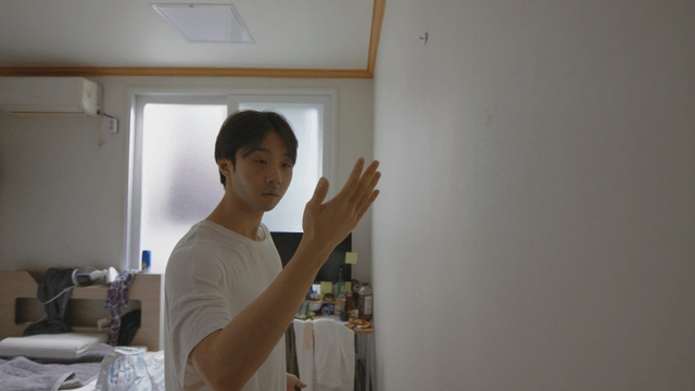 Man looking at his hand after catching a bug