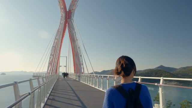 Woman walking on a scenic bridge