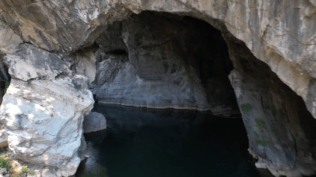 Clear stream beneath quiet cave