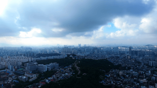 Sprawling cityscape under cloudy skies