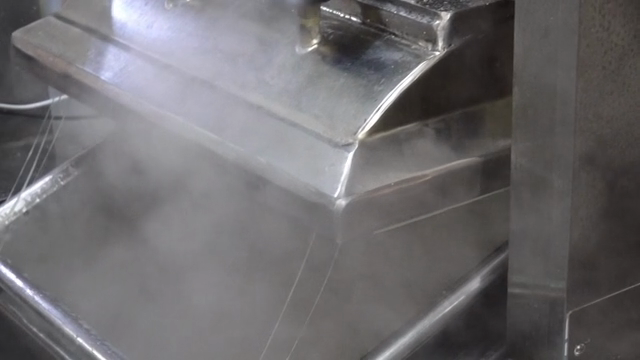 Steam rising from industrial machinery