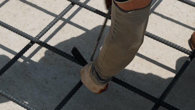 Worker tying rebar at a construction site
