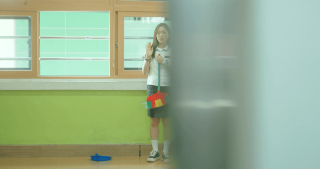 Schoolgirl practicing a greeting alone