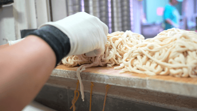 Freshly made noodles on a wooden board