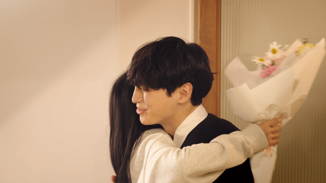 Couple exchanging flowers at the doorway