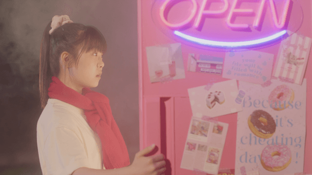 Girl in the red scarf opens a refrigerator full of cold air