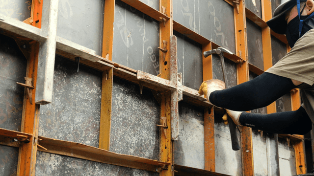 Worker using a hammer on a construction site