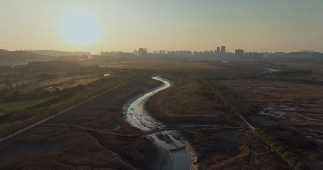A winding river with a city skyline