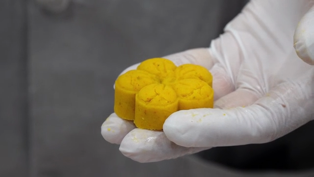 A person holding a flower-shaped dessert