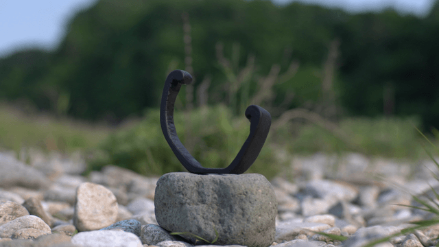 Wooden sculpture placed on a stone field