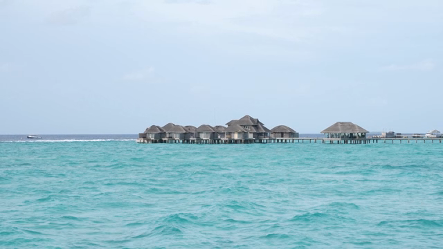 Overwater bungalows on a turquoise sea