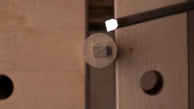 Chiseling a piece of wood by hand