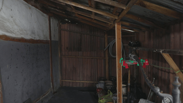 Empty rustic shed with tools and hangers