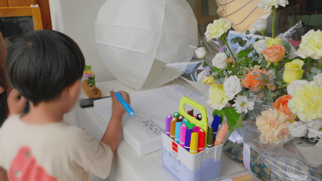 Boy drawing with a marker at a desk