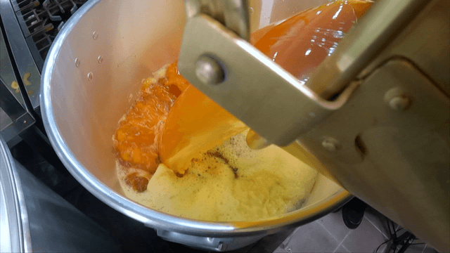 Phellinus linteus chicken broth poured into a large pot in the kitchen