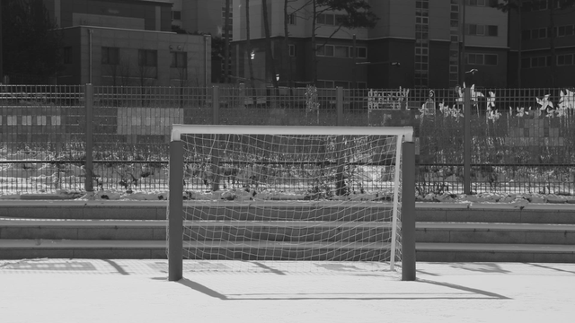Snow-covered soccer goal in a city park