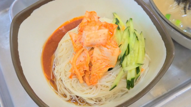 Spicy noodles with cucumber slices and Kimchi