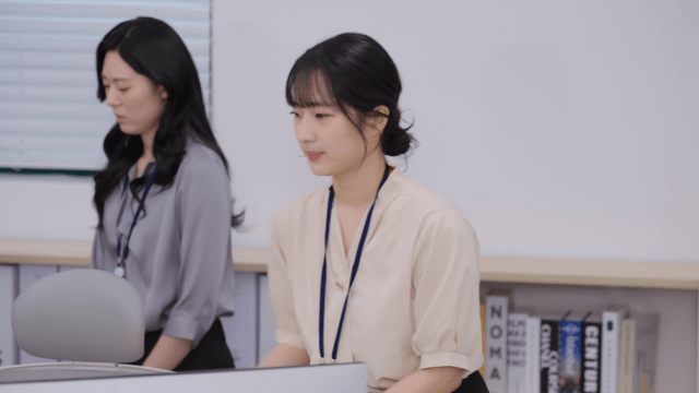 Office workers returning to their seats after being scolded