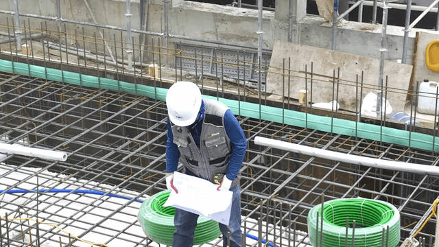 Construction worker reviewing blueprints