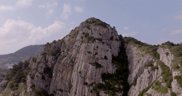A majestic coastal cliff with lush greenery
