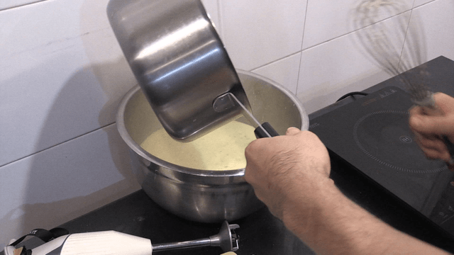 Warm cream poured into mixing bowl