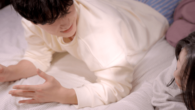 Couple talking together on bed
