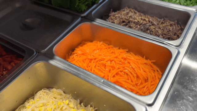 Various Korean side dishes in metal trays