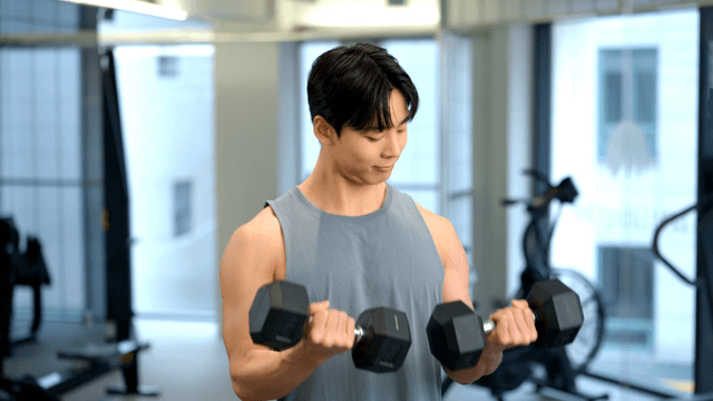 Man lifting dumbbells in a gym