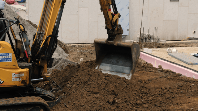 Excavator moving soil at a construction site