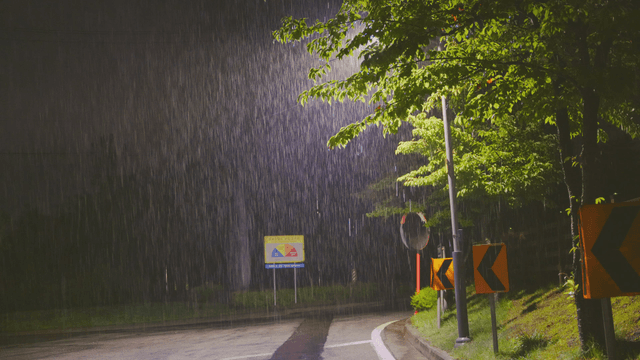 Rain falling on a quiet street at night