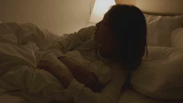 Woman waking up peacefully in bed