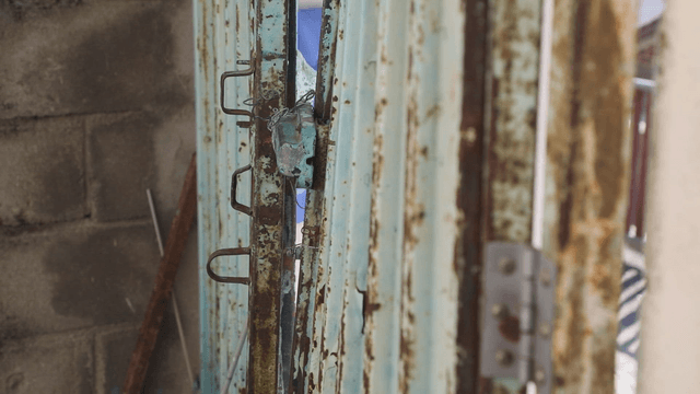 Rusty metal door with a lock