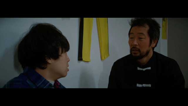 Two men having a serious conversation indoors