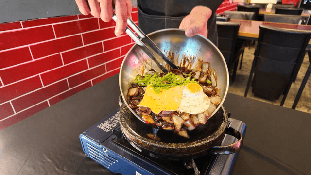Cheese and egg jjajangmyeon on a gas stove iron plate