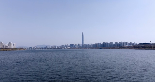 A city skyline with a river in the foreground