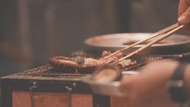 Various mushrooms grilling on barbecue