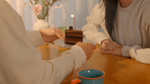 Candle-lit chocolate cake celebration for couple