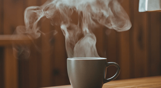 Pouring hot coffee into a mug