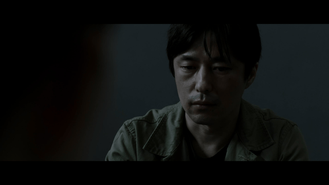 Man grieving in dark room