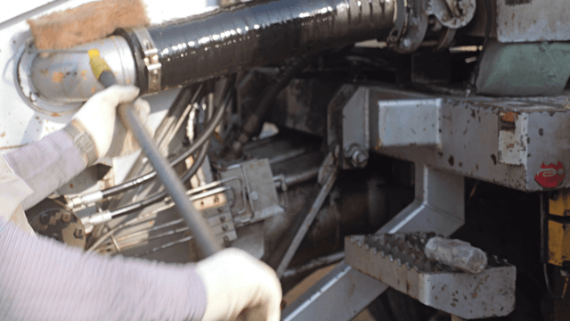 Worker cleaning industrial machinery