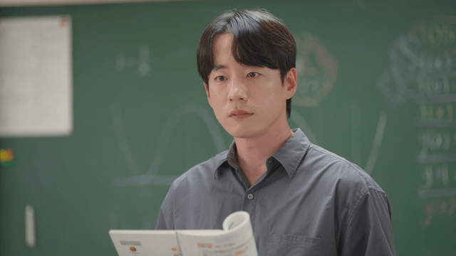 Teacher reading a textbook and communicating with students in the classroom