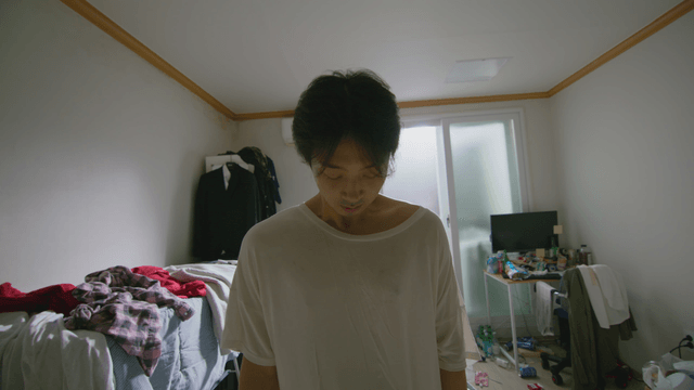 Young man in a cluttered room