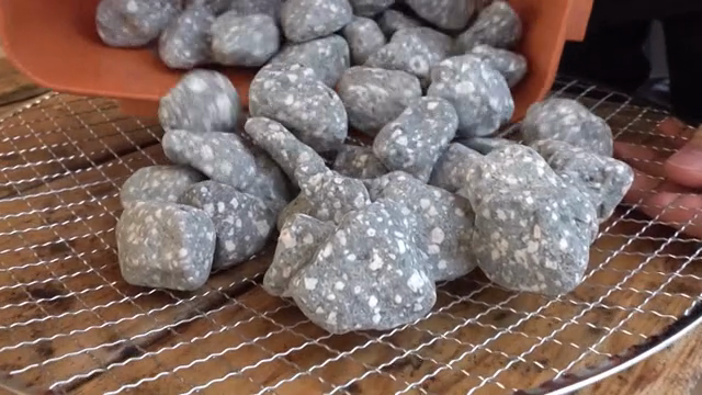 Pouring stones onto a metal grate