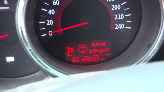 Close-up of car dashboard showing low washer fluid