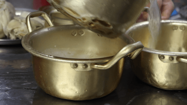 Broth poured into aluminum pots