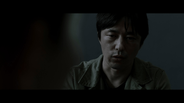 Man interrogating in dark room