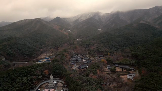Traditional Korean temple surrounded by forest